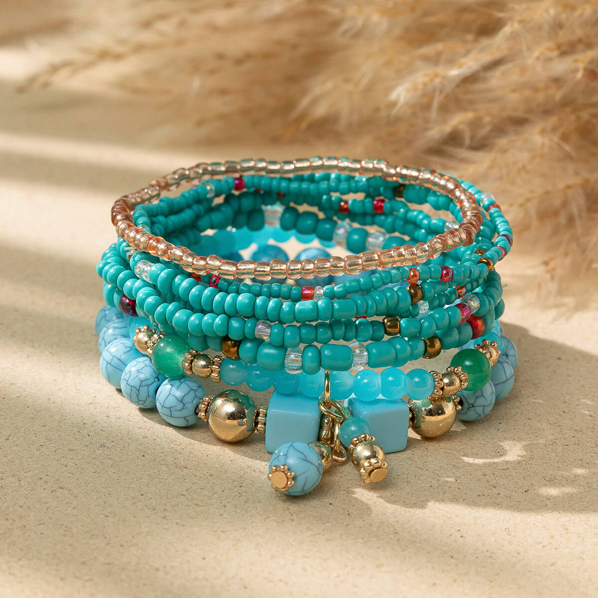 Stack of boho turquoise bead bracelets with gold and colored accents