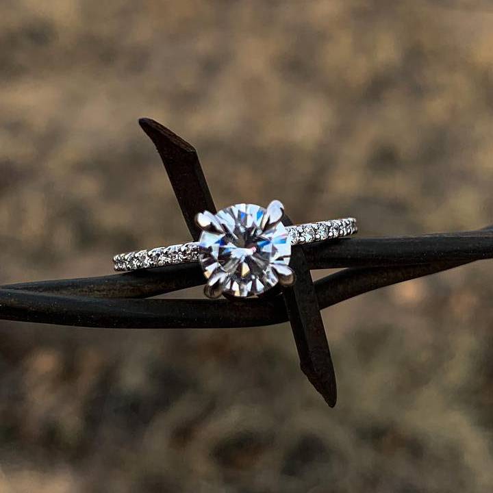 Sterling silver engagement ring with 1ct Moissanite on rustic background