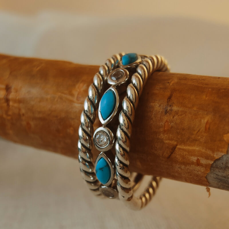 Three stacked sterling silver rings with turquoise and diamond accents
