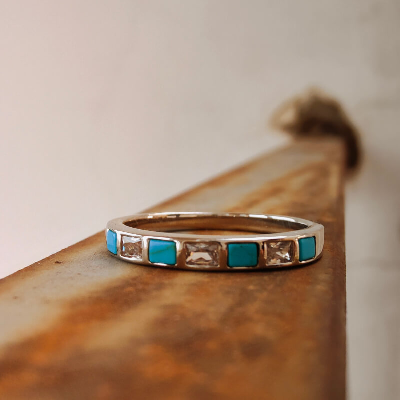 Square turquoise inlay diamond band ring on a rustic background