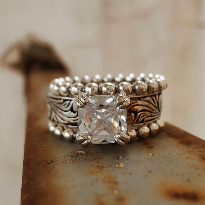 Western-style silver ring with a large zircon stone and detailed engravings