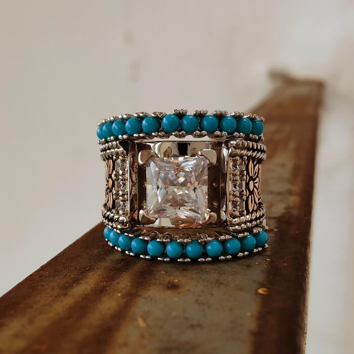 Sterling silver engraved turquoise diamond ring on rustic background