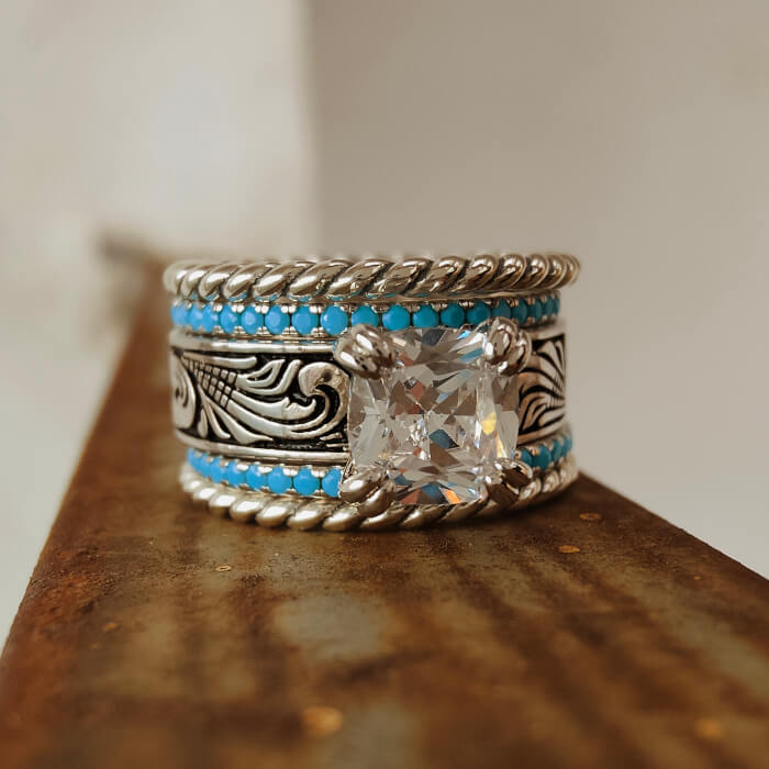 Sterling silver ring with turquoise accents and clear gemstone centerpiece