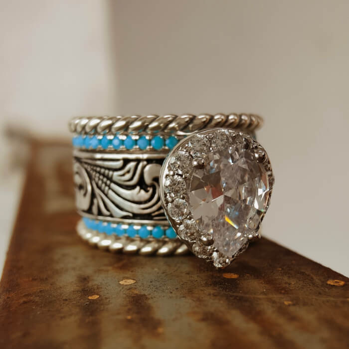 Sterling silver wedding ring with turquoise stones and pear-shaped diamond accent