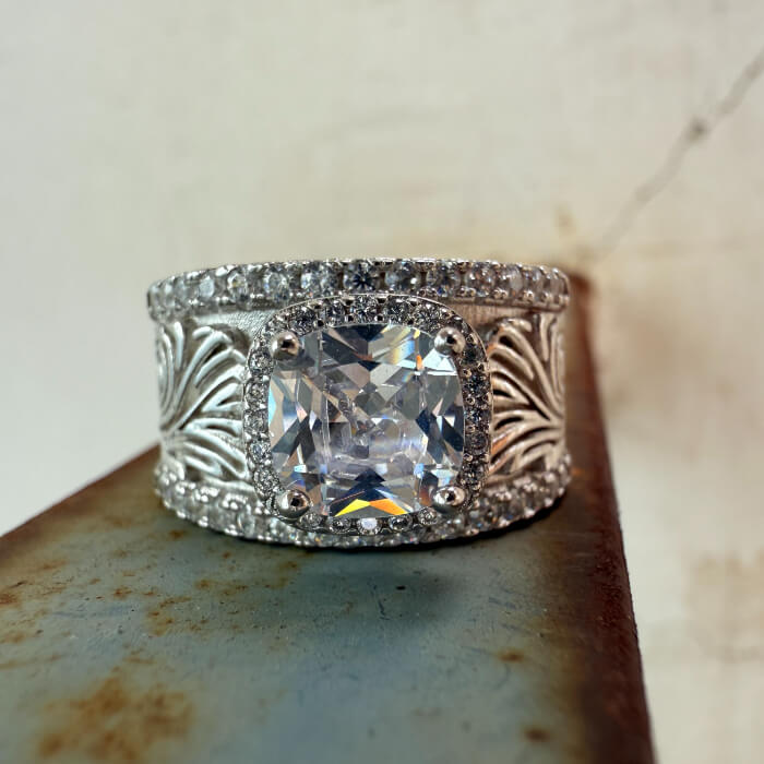 Western-inspired silver ring with flower engravings and zircon center stone