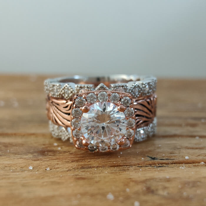 Round moissanite vintage ring in rose gold setting with diamond accents