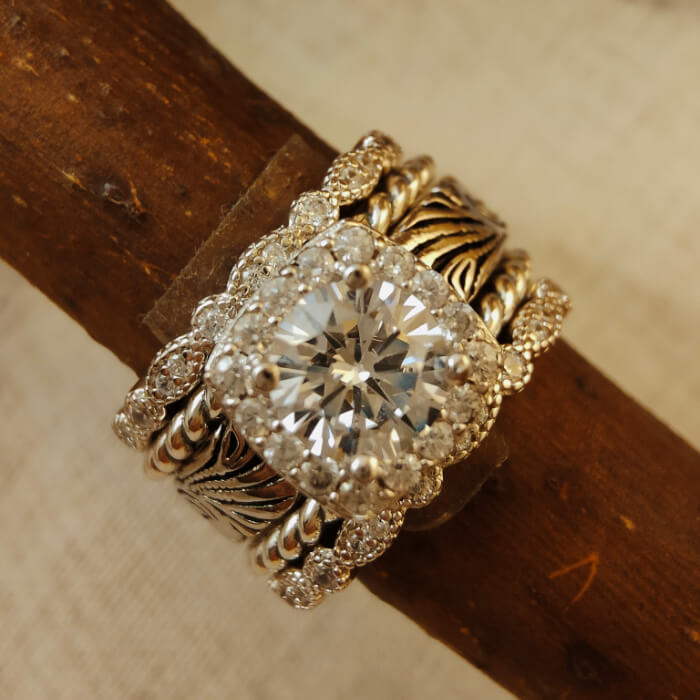 Vintage flower engagement ring with diamond halo and intricate silver band