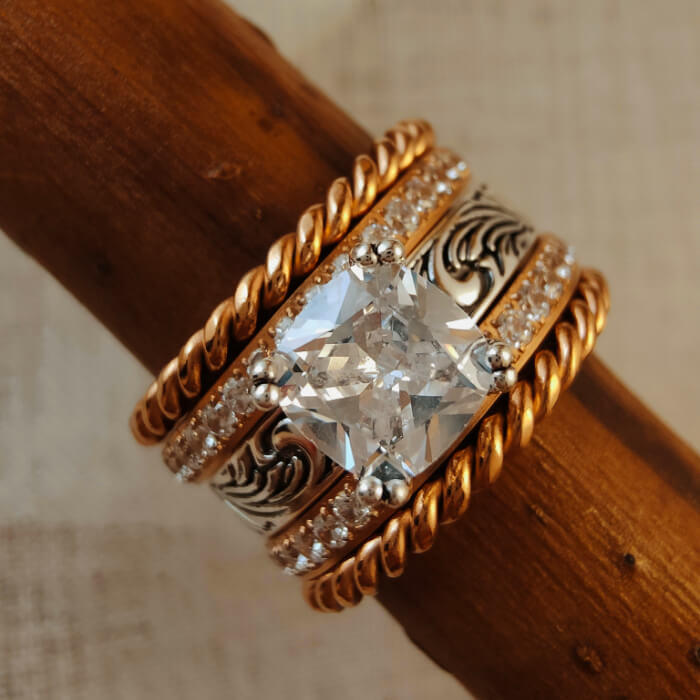 Rose gold engagement ring with twist design and large zircon stone