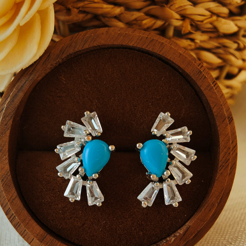 Turquoise and zircon stud earrings with a polished oxidized finish.