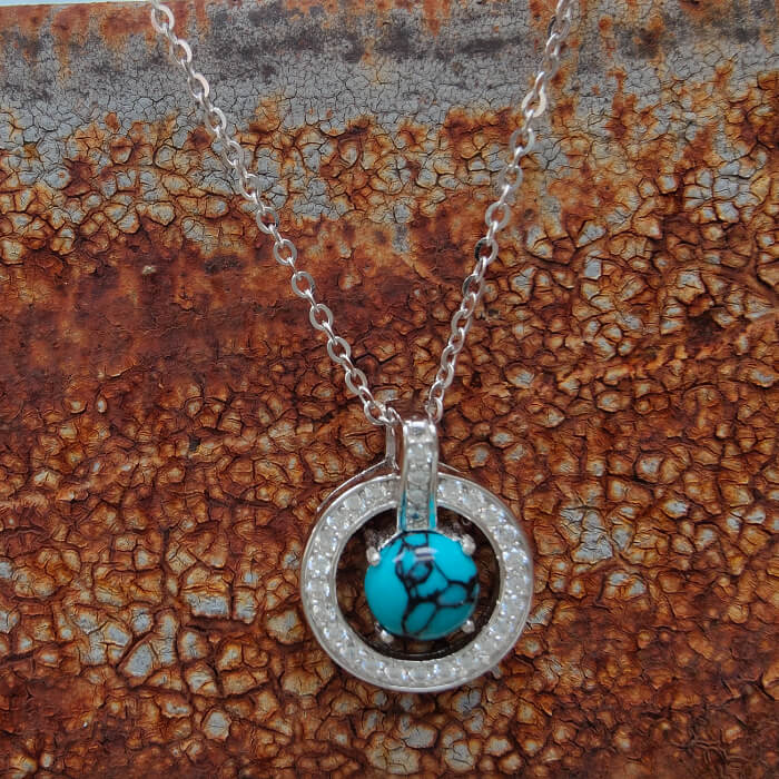 Sterling silver necklace with turquoise and diamond halo pendant