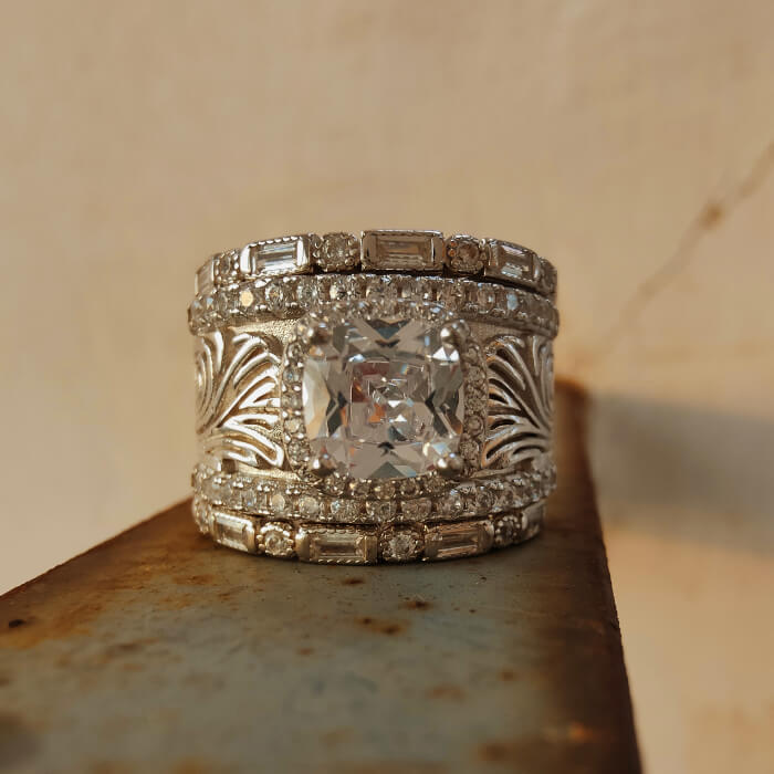 Vintage engagement ring with cushion-cut diamond in engraved silver band