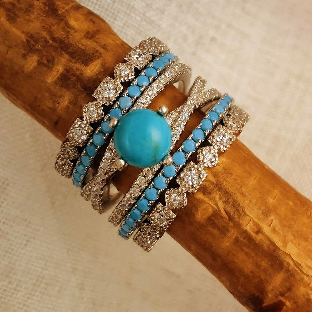 Turquoise and silver ring set with central turquoise stone and diamond accents