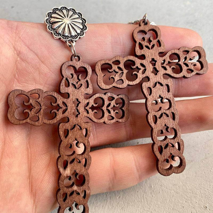 Hollow leather cross earrings with intricate designs and turquoise stone accents