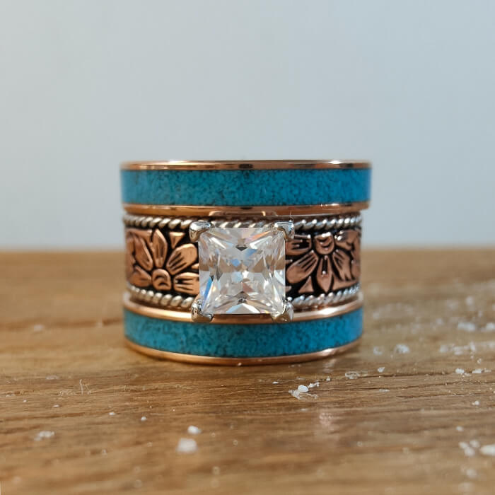 Elegant princess cut turquoise ring with floral engravings and rose gold accents