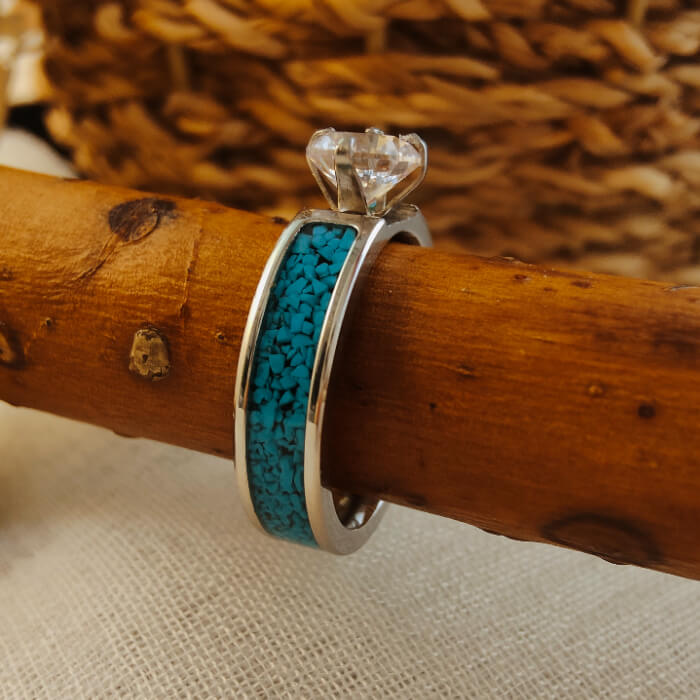 Elegant steel wedding ring with blue turquoise band and zircon accent.