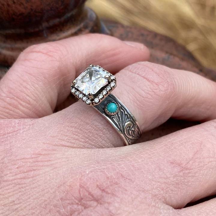Turquoise-accented engagement ring with radiant diamond on engraved silver-black band