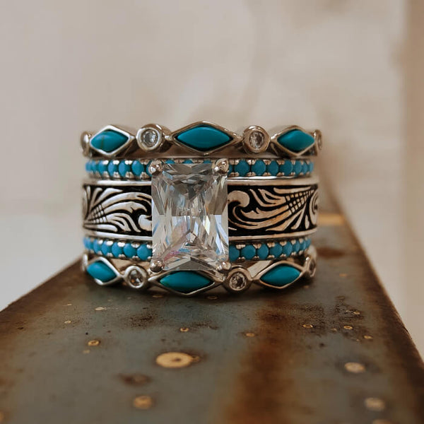 Vintage emerald cut ring with turquoise accents and intricate engravings.