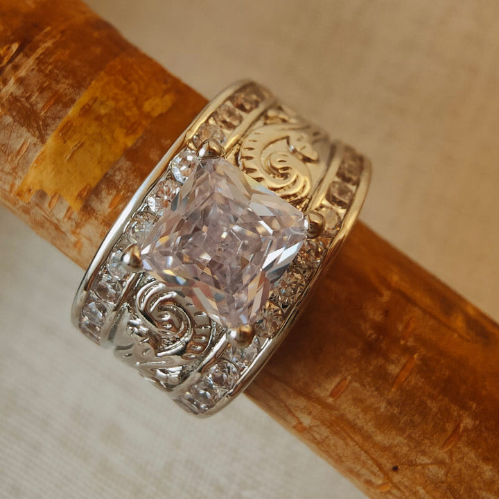 Western engraved diamond wide band ring with zircon stone on wooden background