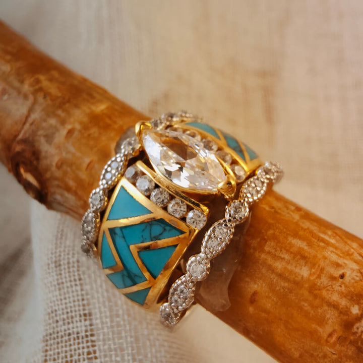 Gold ring featuring marquise diamond with turquoise inlays and diamond accents.