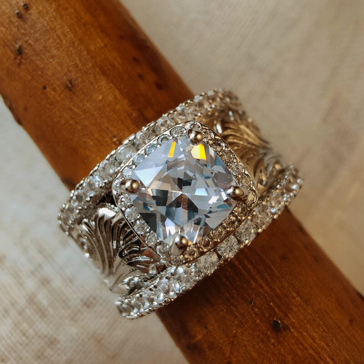 Beautiful silver ring with intricate floral designs and a large sparkly zircon stone.