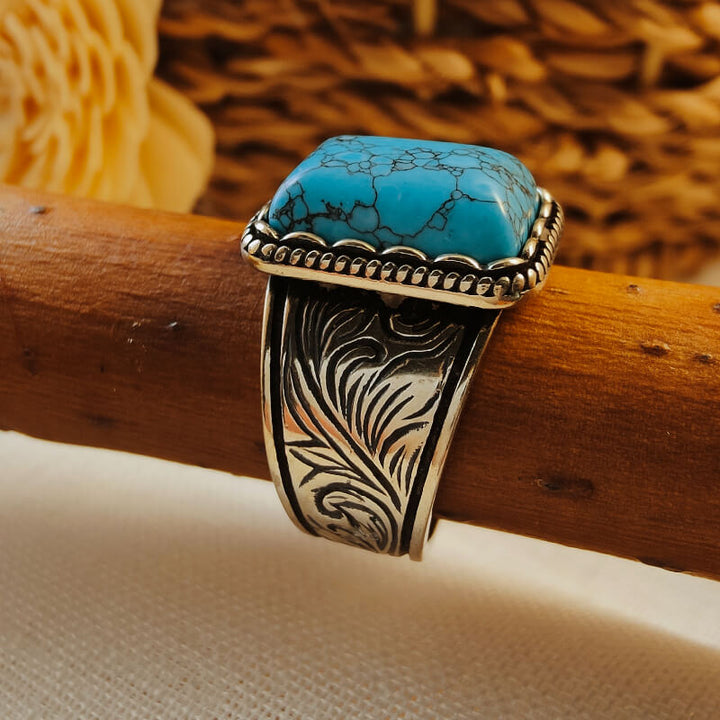 Wide floral engraved silver band turquoise ring with rectangular stone