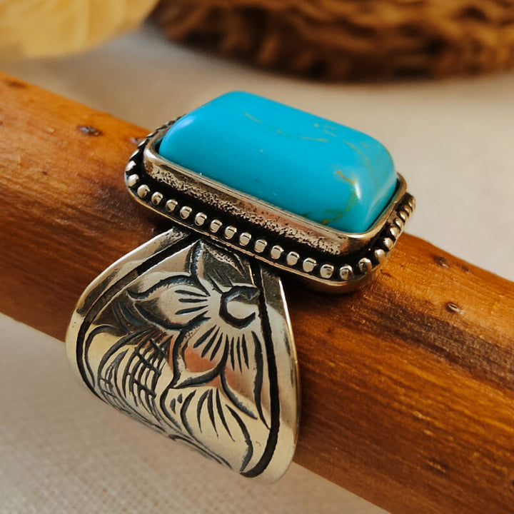Turquoise rectangular ring with floral engravings and beaded edge in silver