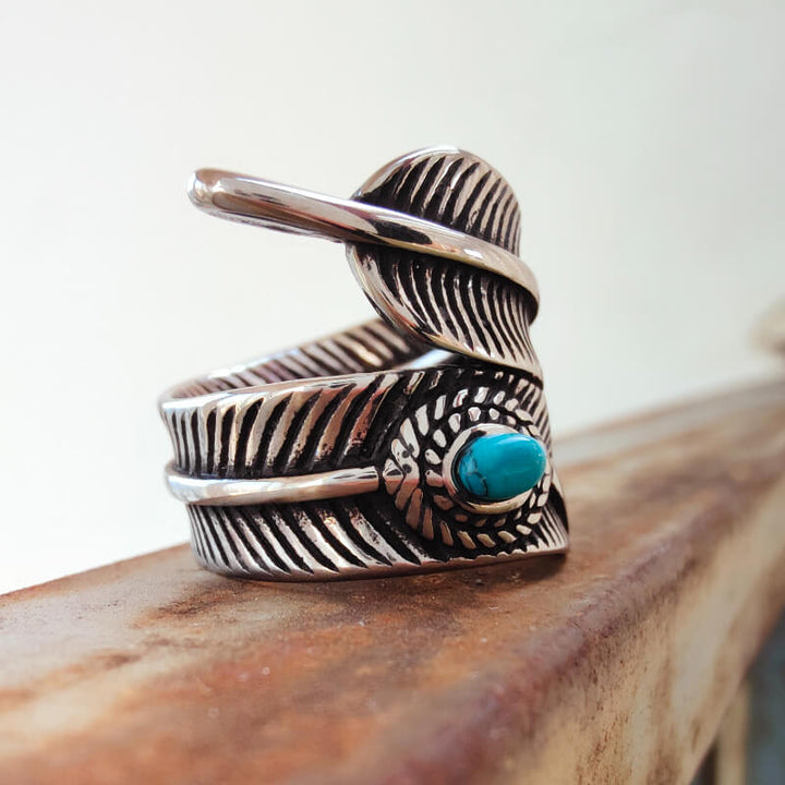 Turquoise stone vintage ring with intricate feather and silver design