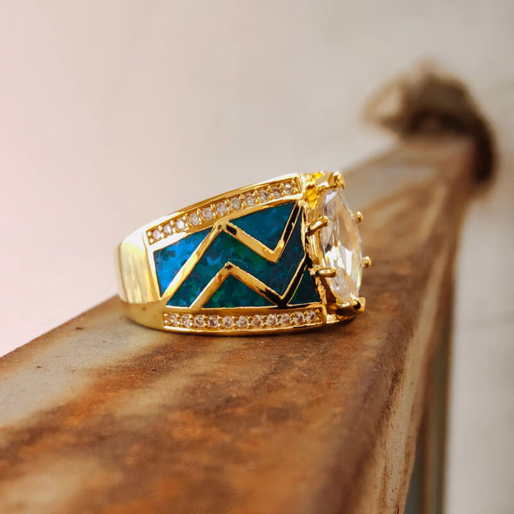 Gold marquise ring featuring blue opal and zircon on zigzag band design