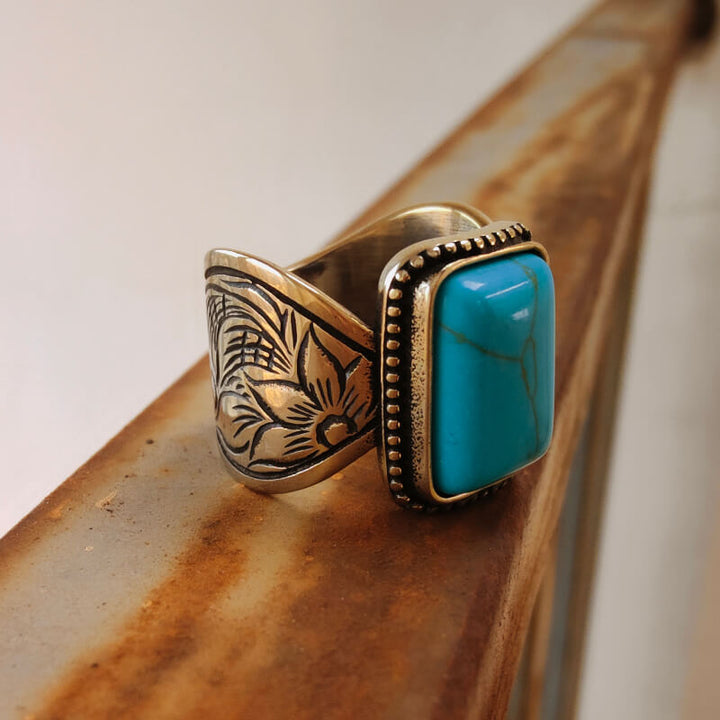 Rectangular turquoise ring with floral wave band and intricate silver detailing