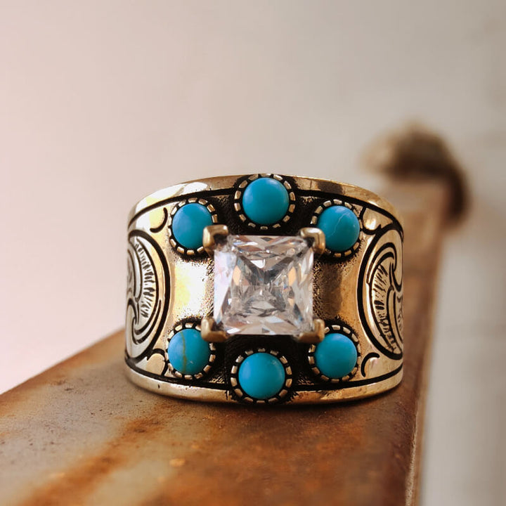 Wide band turquoise engagement ring with diamond center and floral engravings