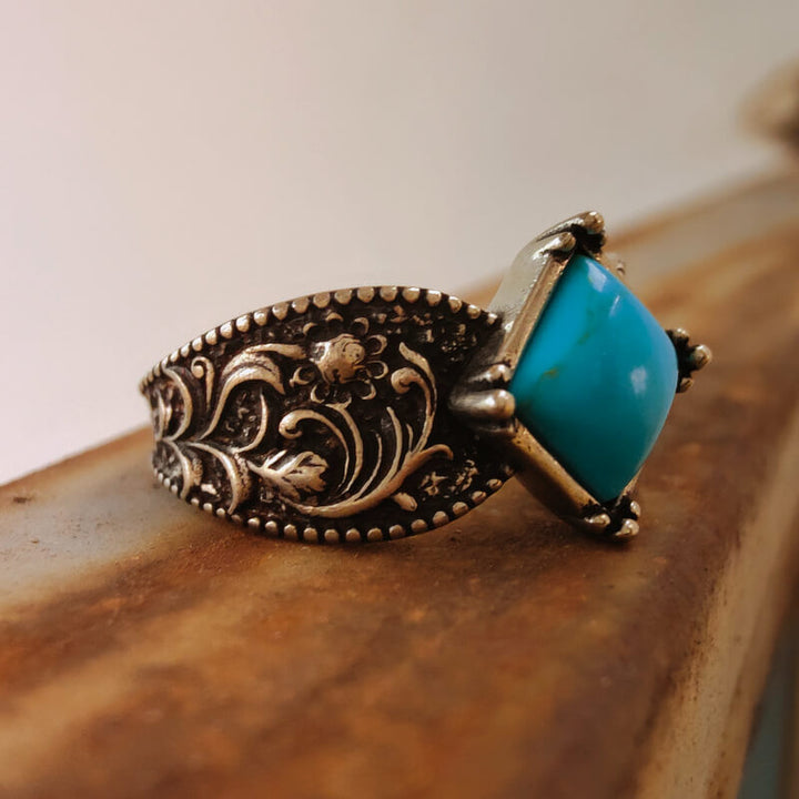 Silver ring with square turquoise stone and floral engravings