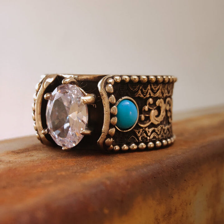 Close-up of Wave Engraved Turquoise Diamond Ring with ornate design