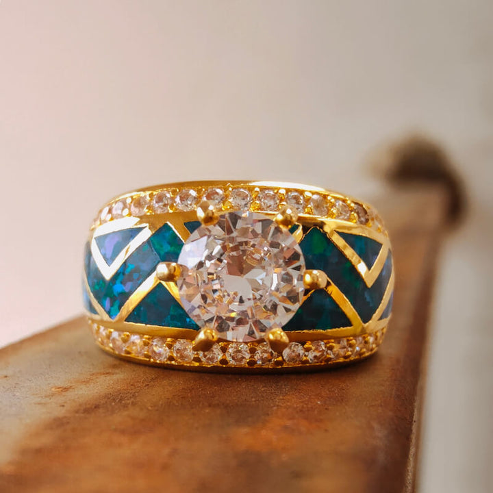 Elegant blue opal and diamond engagement ring with gold band and intricate design