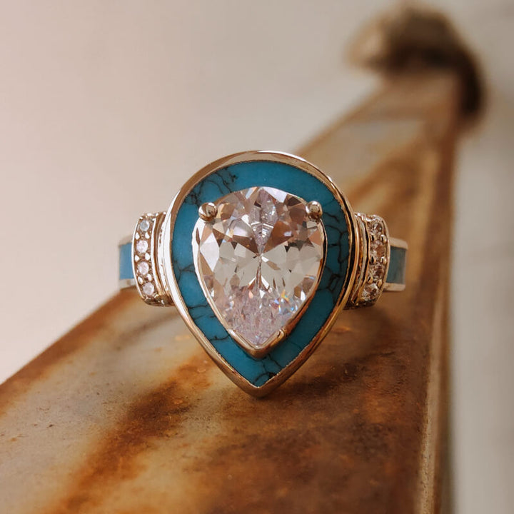 Turquoise inlay pear engagement ring with diamond side accents