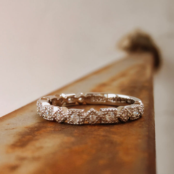 Sterling silver vintage diamond square band ring on rustic background