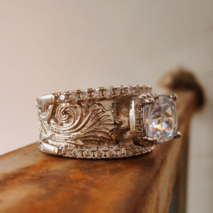 Statement silver ring with floral engravings and a large clear zircon stone
