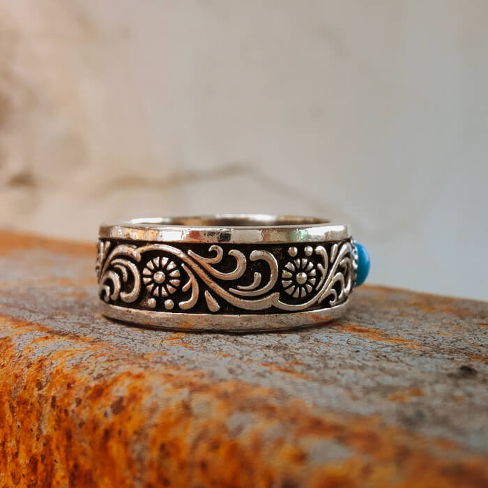 Western-style engraved steel ring featuring blue turquoise centerpiece