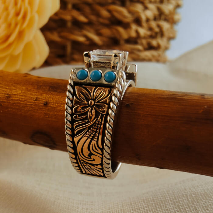 Silver-black floral ring with turquoise stones and clear center gem