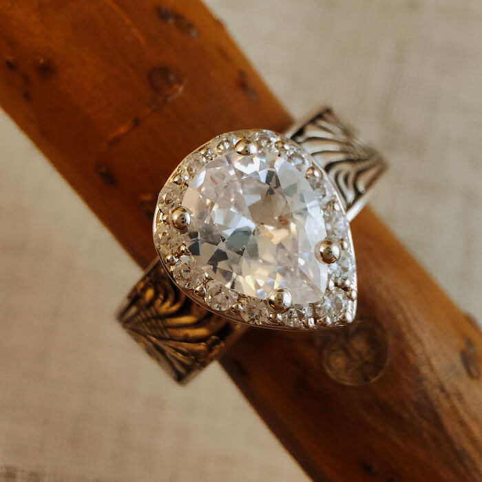 Sterling silver pear-shaped diamond engagement ring with floral engraving