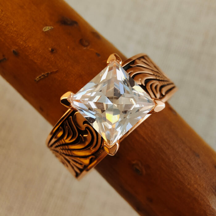 Rose gold wedding ring showcasing a large square zircon with floral details.
