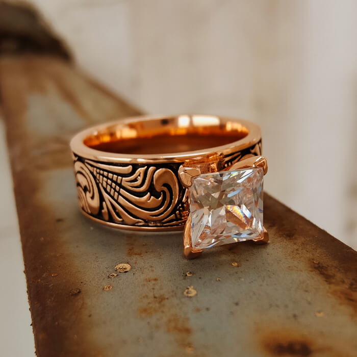 Rose gold Western wedding ring with detailed engravings and large square zircon.
