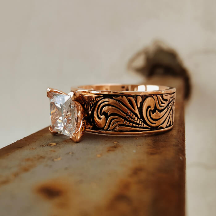 Engraved rose gold ring featuring a large square zircon stone.