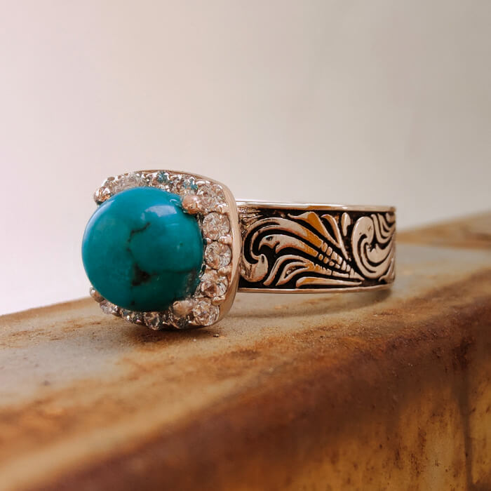Turquoise ring with floral engravings and diamond halo on silver-black band