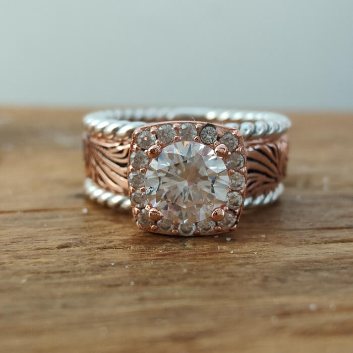 Rose gold promise ring featuring round Moissanite and diamond halo accents
