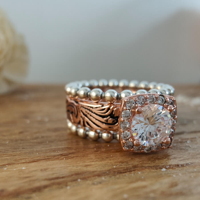 3-piece rose gold and silver bead ring set with ornate band and large central moissanite stone