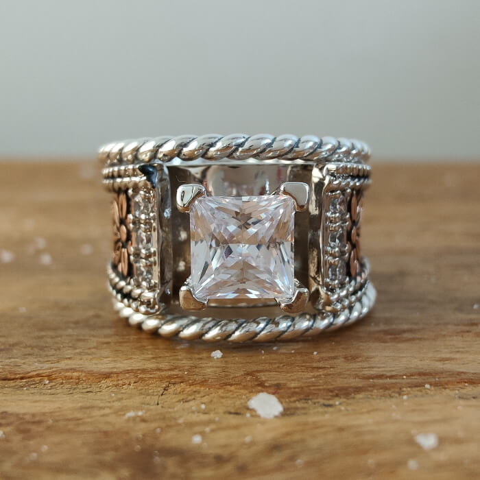 Sterling silver twist band engagement ring with square diamond and floral details