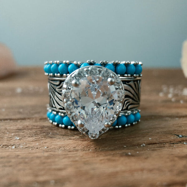 Sterling silver engagement ring with pear-cut zircon and turquoise beads