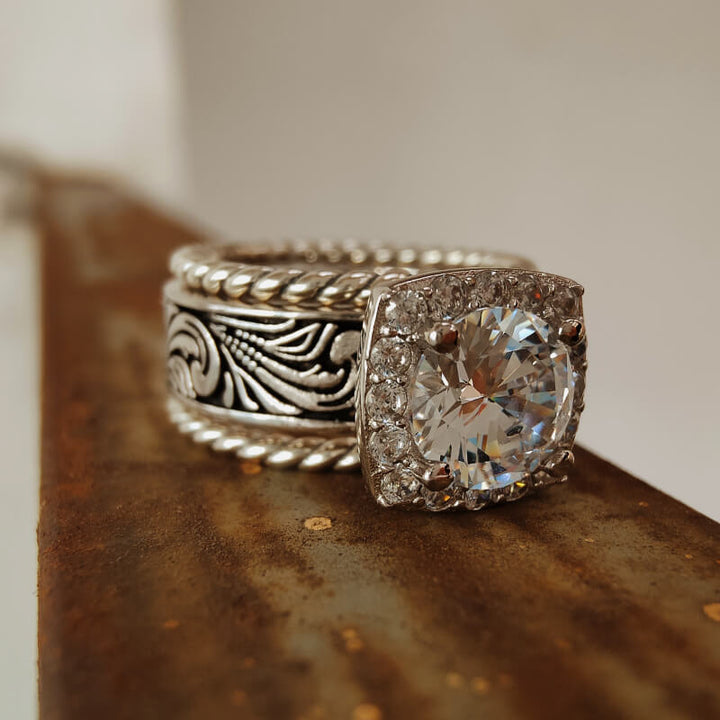 Twist floral silver engagement ring set with large diamond centerpiece.