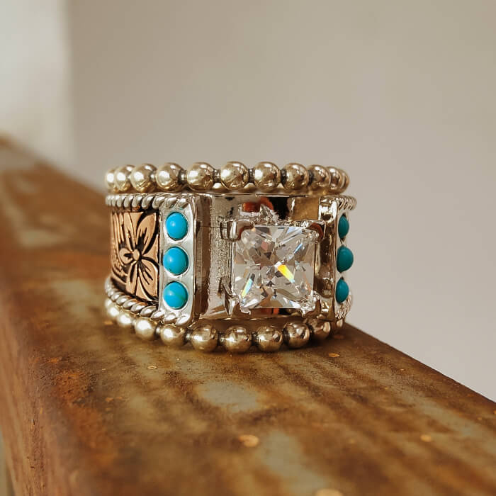 Western-style ring with square diamond and turquoise stones in ornate band