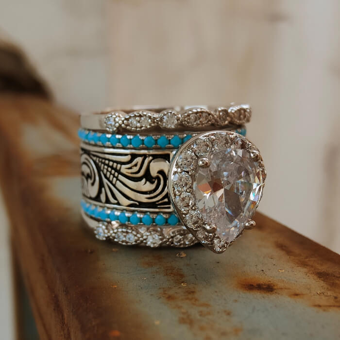 Vintage five-piece turquoise diamond ring set with pear-cut center stone and silver design.